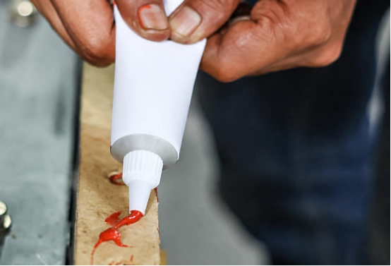 applying high temperature red RTV silicone sealant